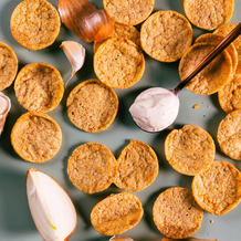 Assorted cookies on a gray surface with a spoon