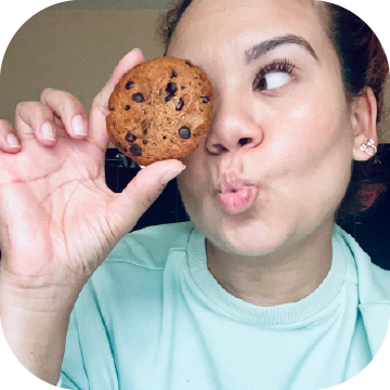 Wonderslim Protein Cookie, Chocolate Chip being held over Wonderslim Ambassador's eye