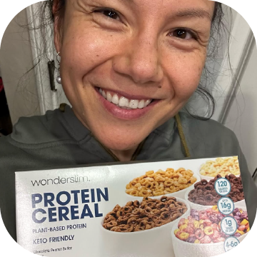 Wonderslim Protein Cereal, Variety Pack being held by a smiling Wonderslim Ambassador